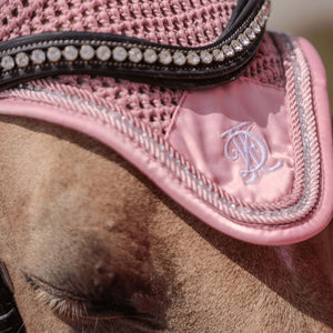 
                  
                    Close up of pink fly veil with pink and diamante trim, modelled on a palomino horse.
                  
                